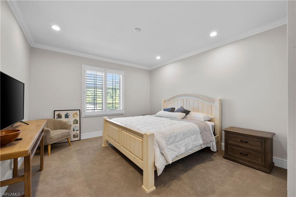 55 Burning Tree Drive Naples, FL 34105 - Photo 29 of 45 a bedroom with a bed and a tv