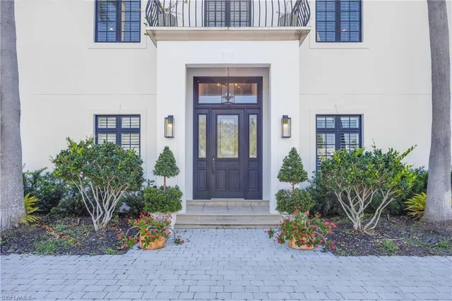 a front view of a house with outdoor seating
