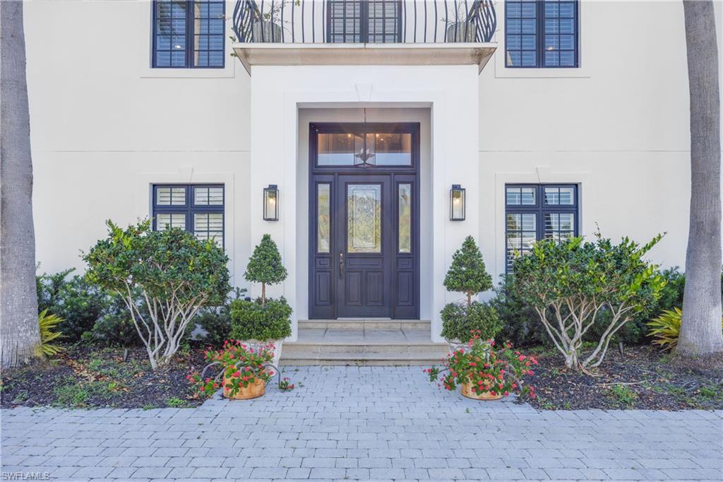 55 Burning Tree Drive Naples, FL 34105 - Photo 3 of 45 a front view of a house with outdoor seating