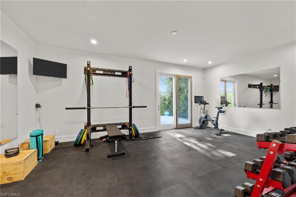 55 Burning Tree Drive Naples, FL 34105 - Photo 35 of 45 a view of a room with gym equipment