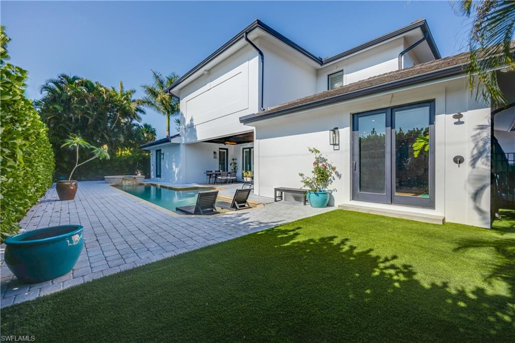 55 Burning Tree Drive Naples, FL 34105 - Photo 39 of 45 a view of a house with backyard and sitting area
