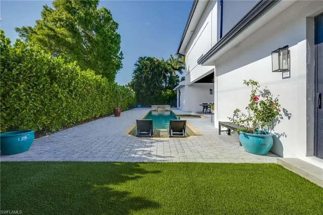 a view of a house with backyard sitting area and garden