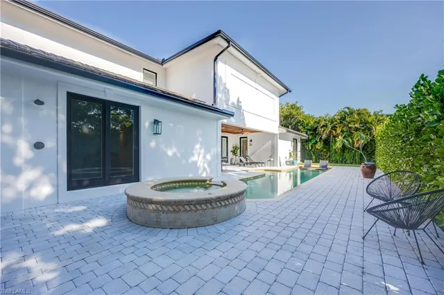 a view of an house with backyard space and balcony