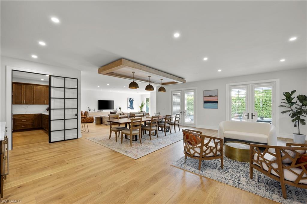 55 Burning Tree Drive Naples, FL 34105 - Photo 6 of 45 a living room with furniture and a wooden floor