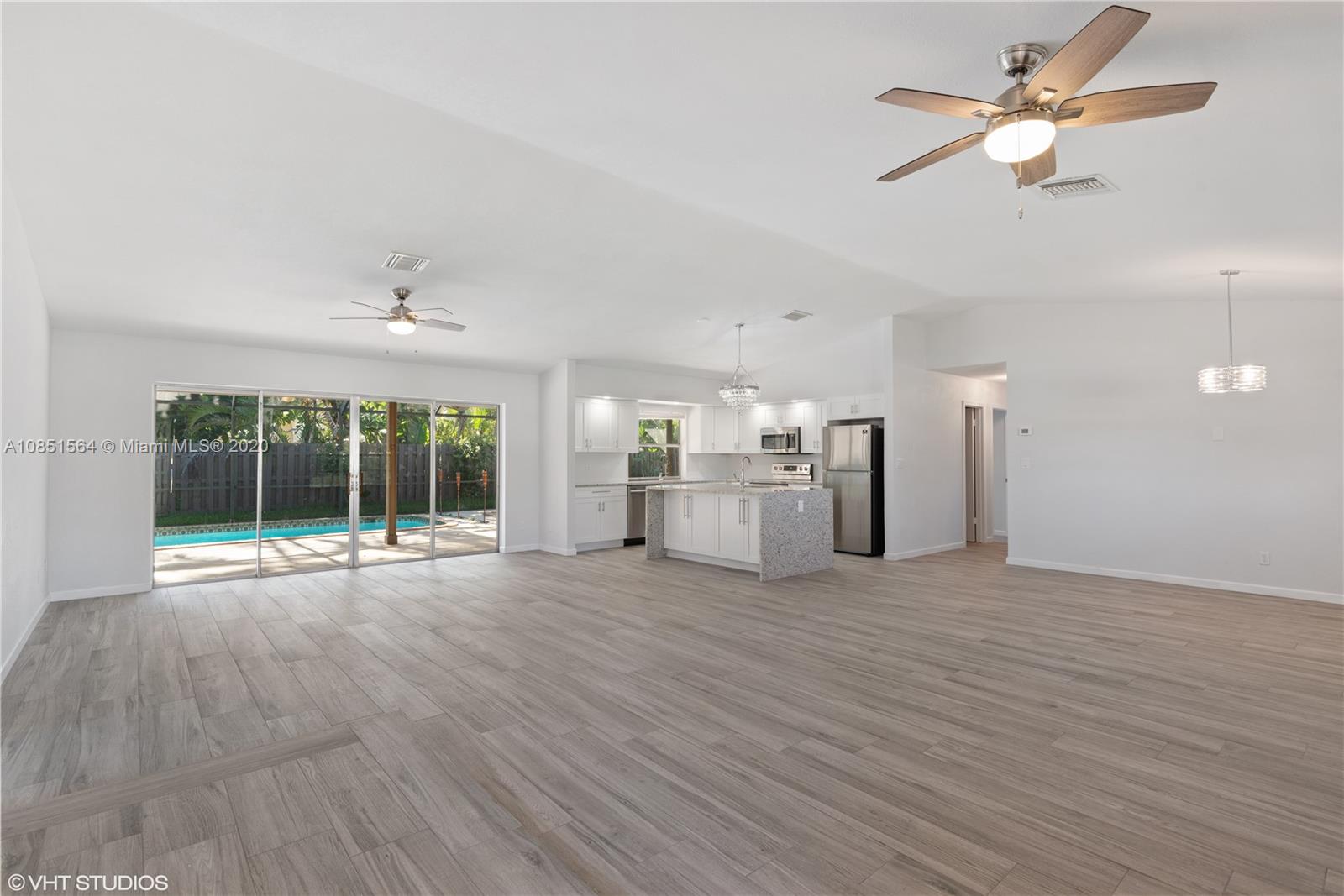 17735 Raintree Terrace Boca Raton, FL 33487 - Photo 6 of 18 a view of an empty room with a window and kitchen view