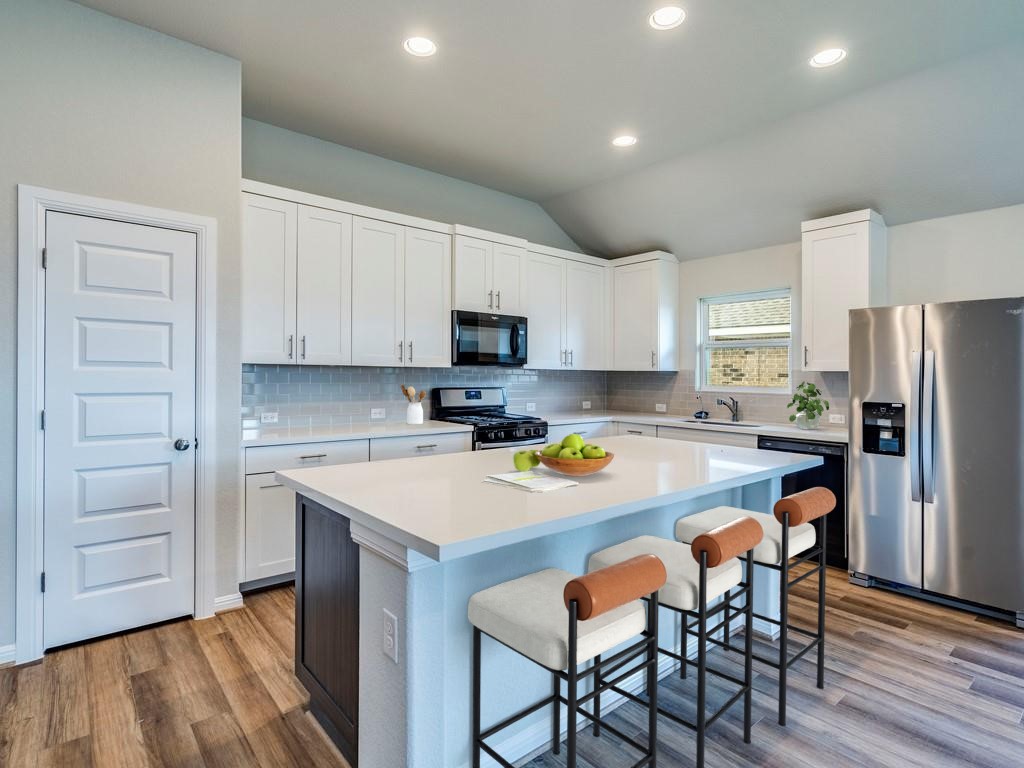 270 Rimrock Court Bastrop, TX 78602 - Photo 4 of 34 Inside, the open-concept kitchen is the heart of the home, featuring stainless steel appliances, a generous island, and plenty of space to gather, cook, and connect.