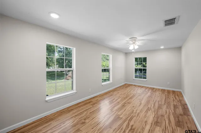 a bedroom with a large bed and a window