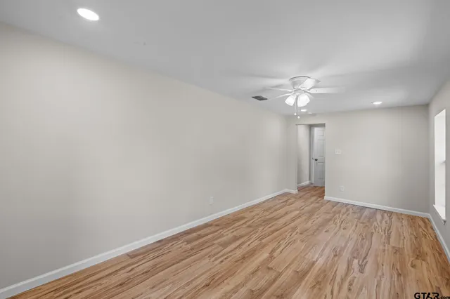 a view of hallway with wooden floor