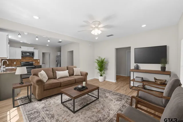 a kitchen with granite countertop a refrigerator and a stove top oven