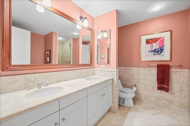 a spacious bathroom with a granite countertop sink and a mirror