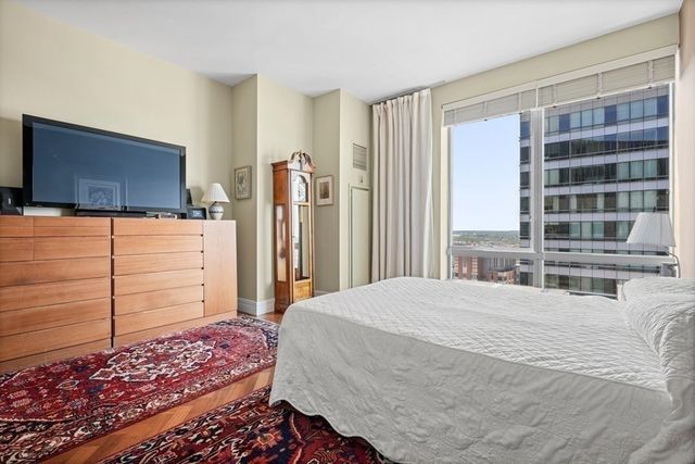 a bedroom with a bed and flat screen tv