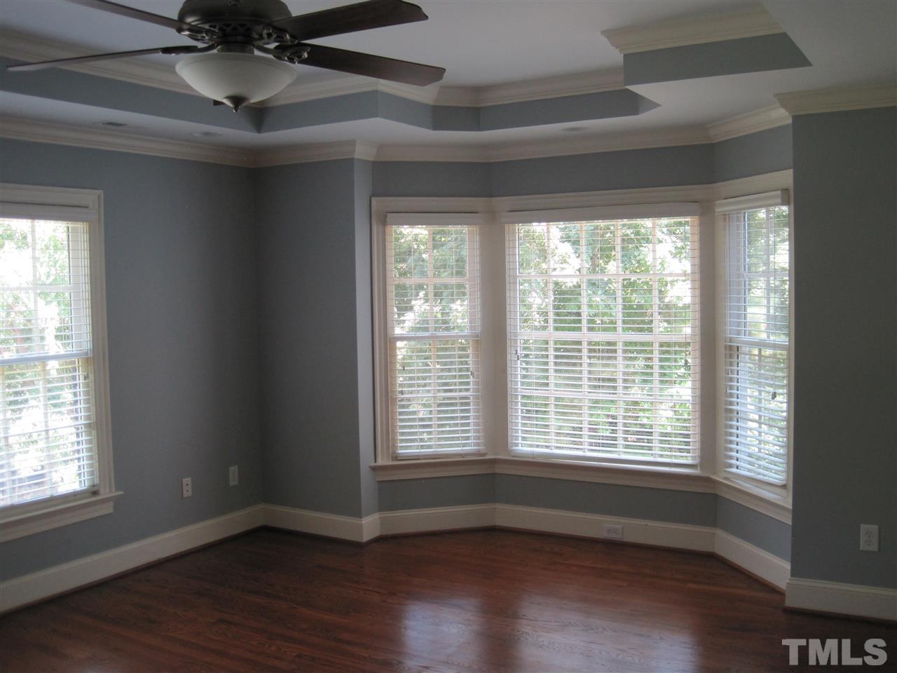 11020 Brass Kettle Road Raleigh, NC 27614 - Photo 12 of 25 Master Bedroom with tray ceiling, ceiling fan, bay window and hardwood floors.