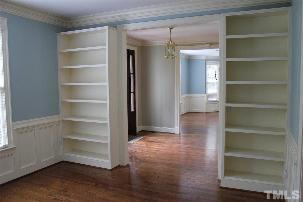 11020 Brass Kettle Road Raleigh, NC 27614 - Photo 3 of 25 Formal Living Room with wainscot, bookshelves and hardwood floors.