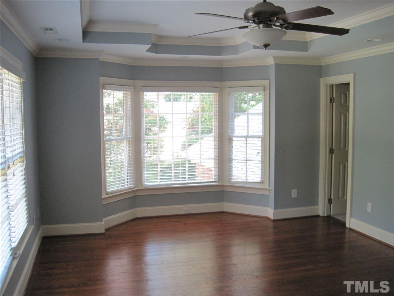 11020 Brass Kettle Road Raleigh, NC 27614 - Photo 4 of 25 Dining Room with wainscot, bay window and hardwood floors.