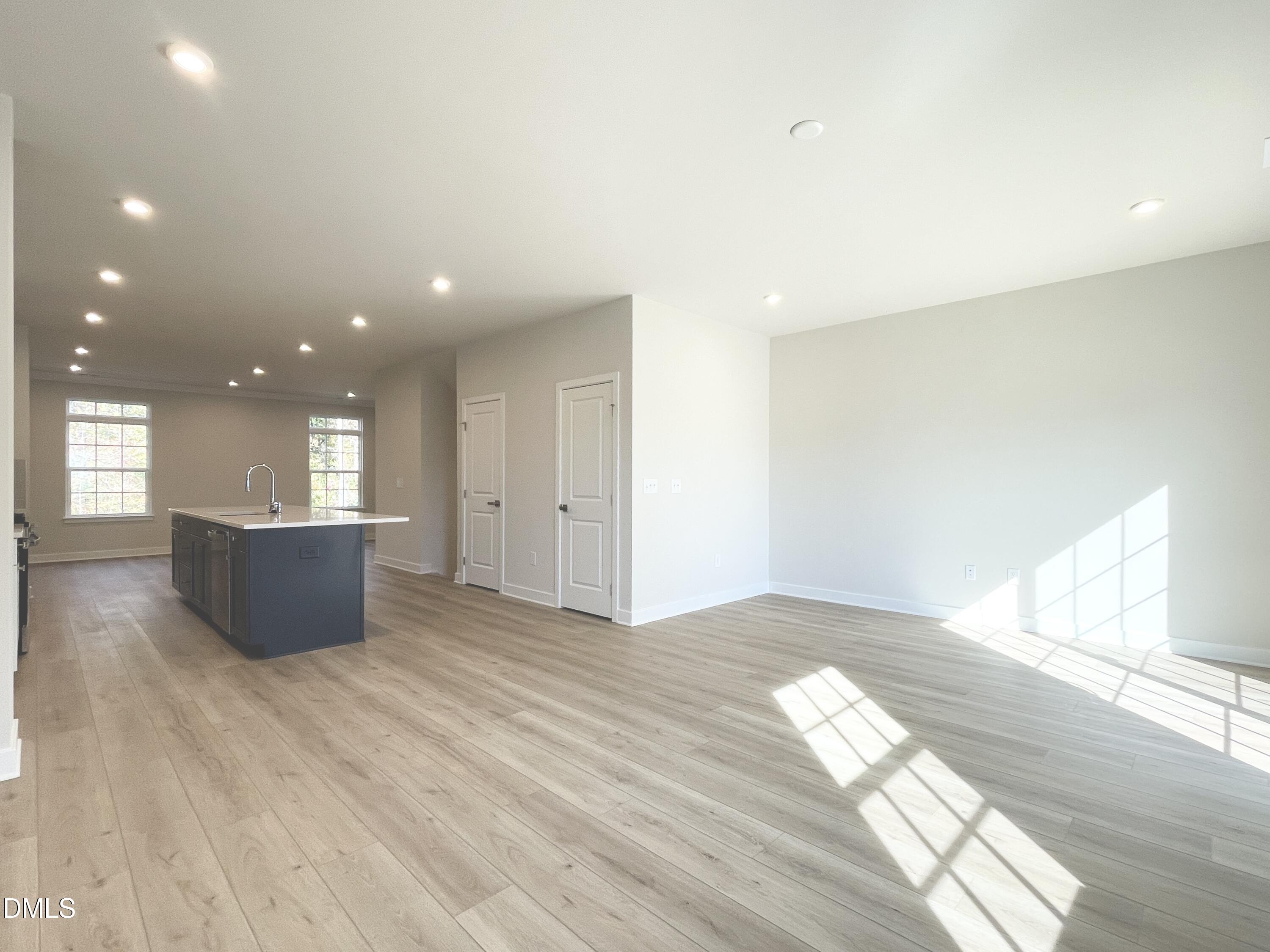 2305 Pitchfork Lane Durham, NC 27713 - Photo 11 of 27 an empty room with wooden floor and windows