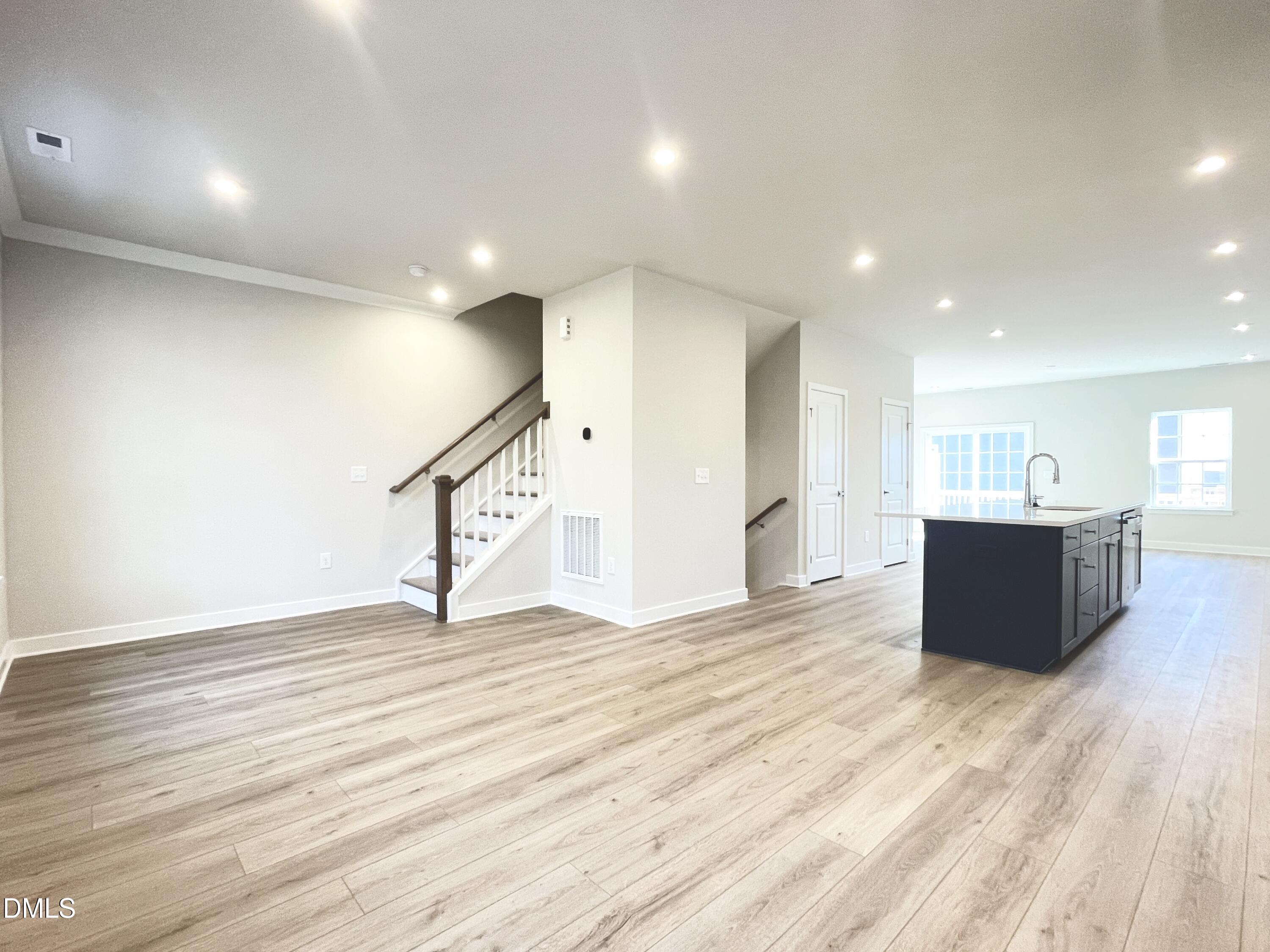 2305 Pitchfork Lane Durham, NC 27713 - Photo 13 of 27 a view of an empty room with wooden floor and windows