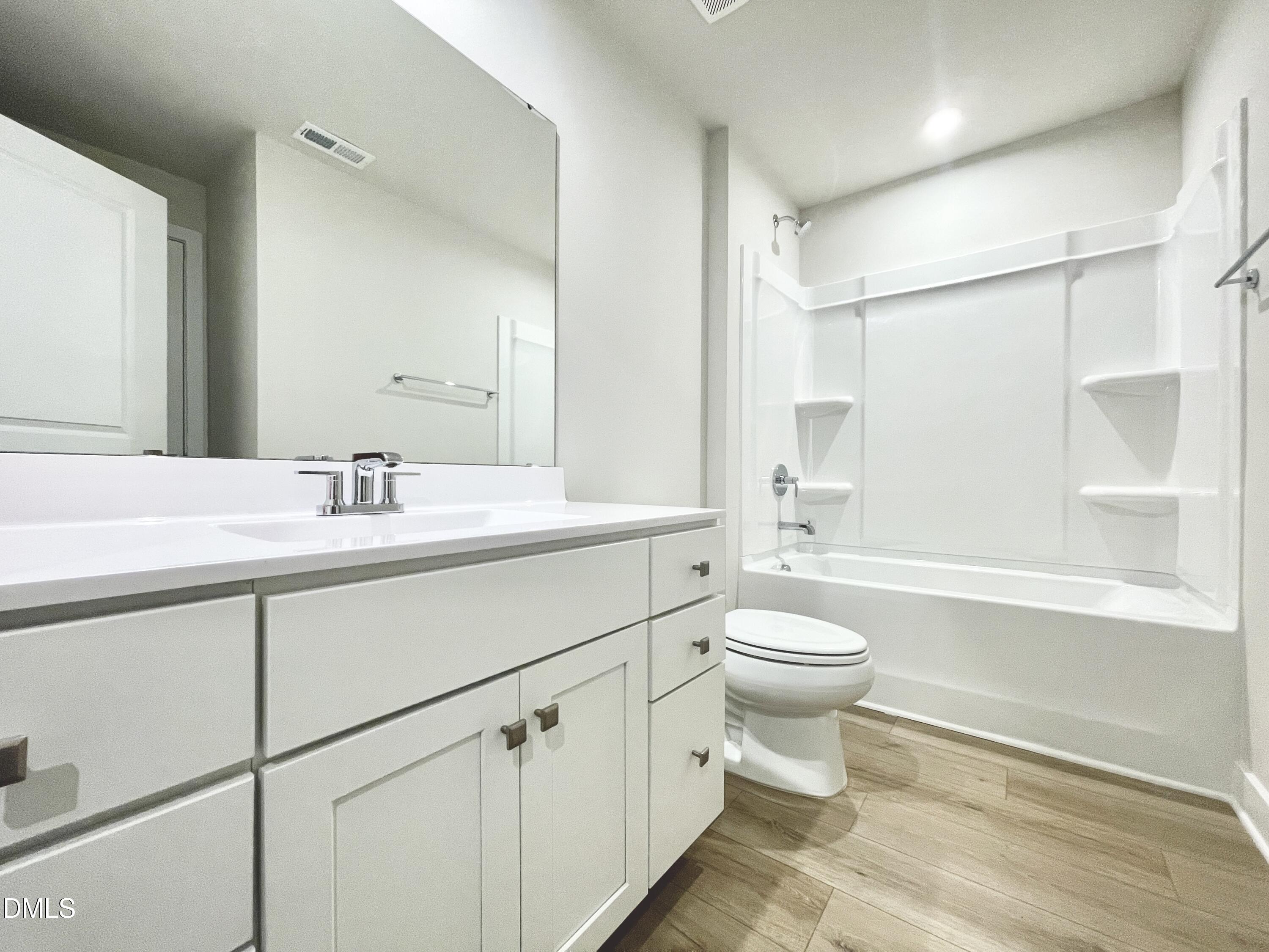 2305 Pitchfork Lane Durham, NC 27713 - Photo 6 of 27 a bathroom with a sink a toilet and shower