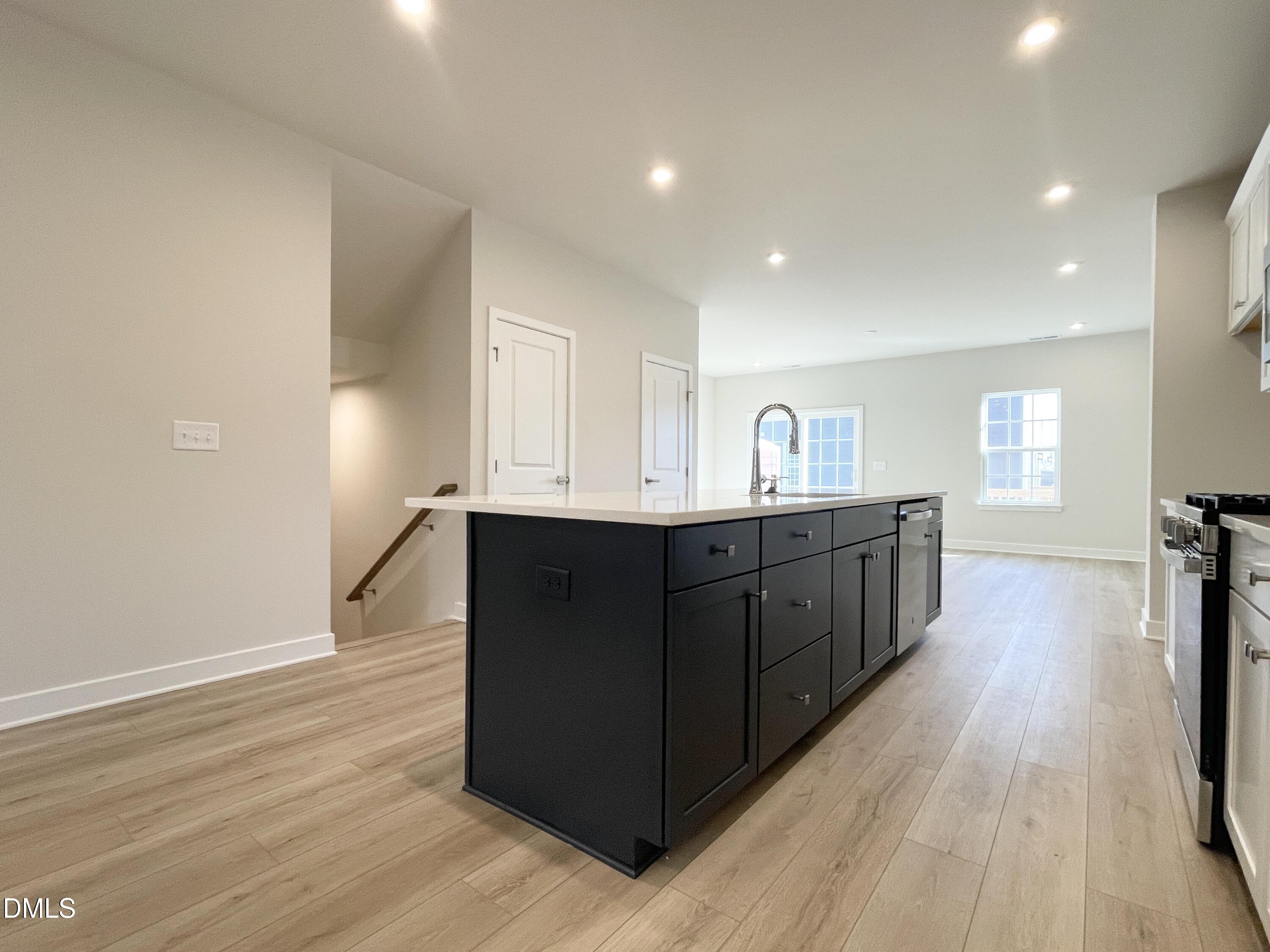 2305 Pitchfork Lane Durham, NC 27713 - Photo 8 of 27 a kitchen with stainless steel appliances granite countertop a sink and cabinets