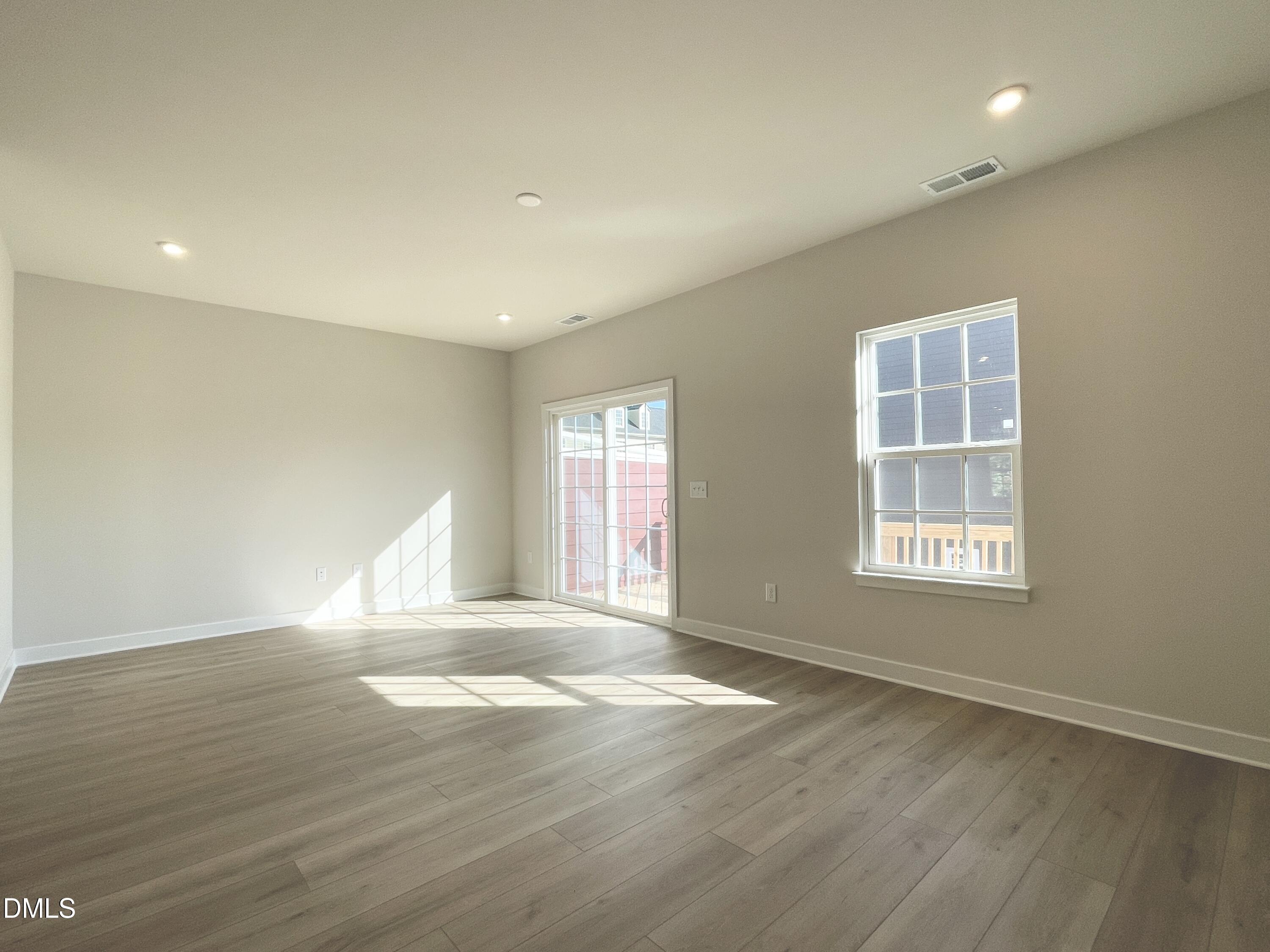 2305 Pitchfork Lane Durham, NC 27713 - Photo 10 of 27 a view of an empty room with wooden floor and window