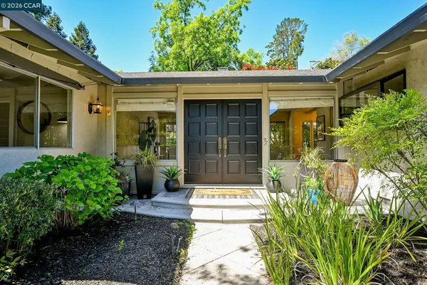 a front view of a house with a garden