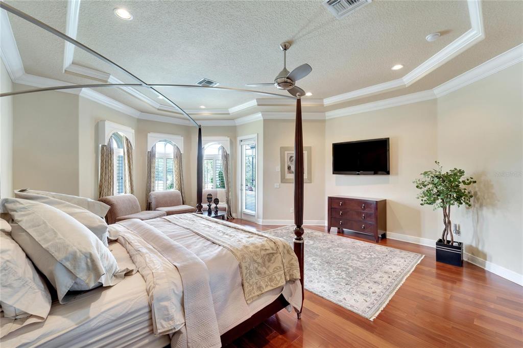 15101 Kestrelglen Way Lithia, FL 33547 - Photo 40 of 75 a spacious bedroom with a large bed and a flat screen tv
