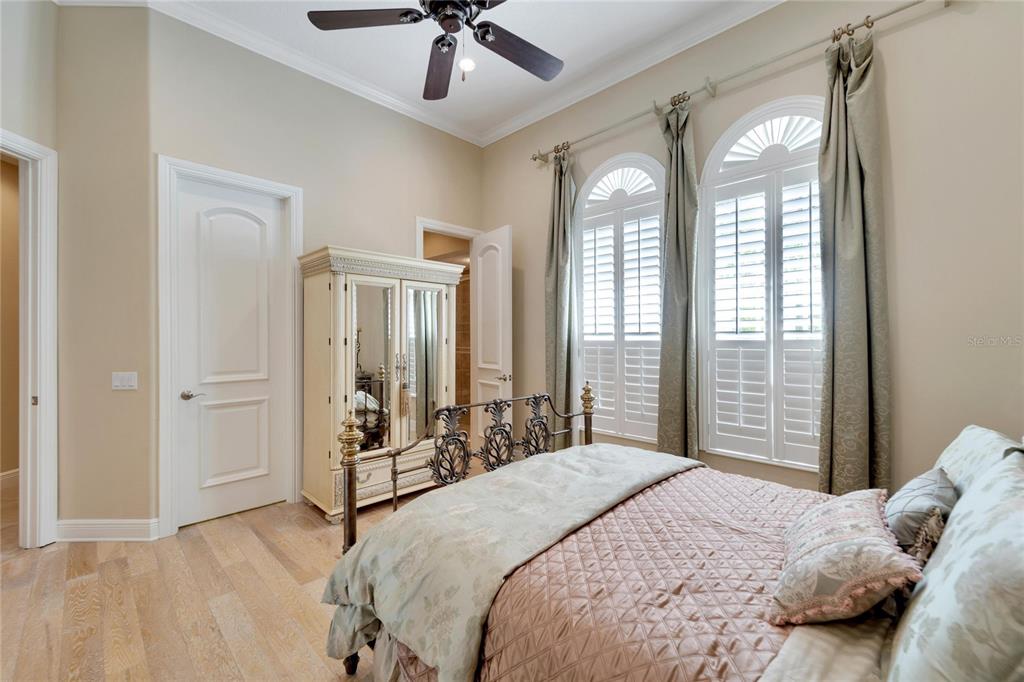 15101 Kestrelglen Way Lithia, FL 33547 - Photo 57 of 75 a bedroom with a large bed and a chandelier