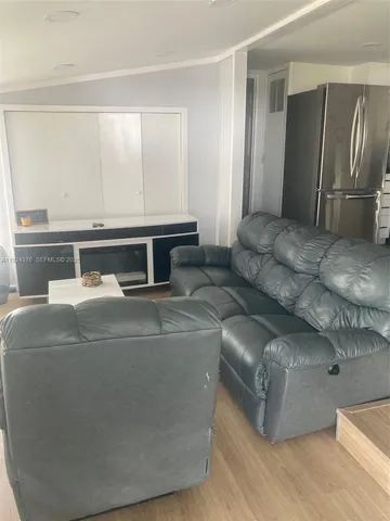 a living room with furniture and a air conditioner