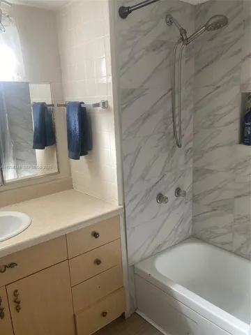 a bathroom with a bathtub and shower