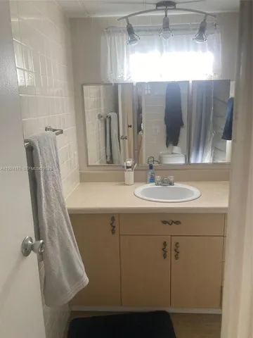 a bathroom with a sink and mirror