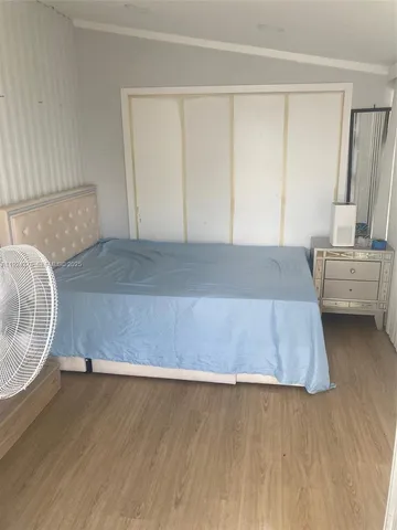 a room with a bed and a potted plant