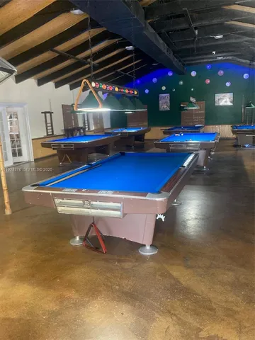 a roof deck with table and chairs a barbeque with wooden floor