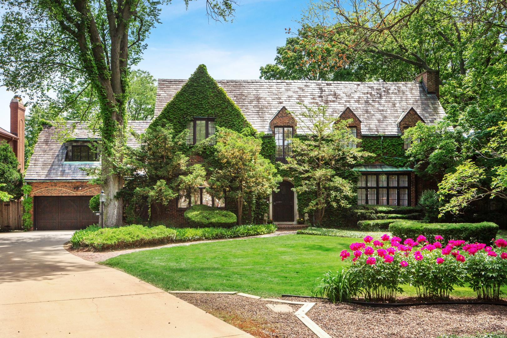 801 South County Line Road Hinsdale, IL 60521 - Photo 1 of 24 a front view of a house with a yard and potted plants