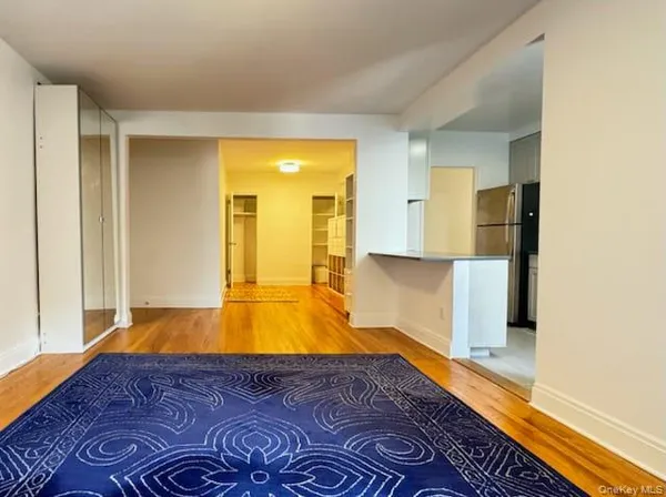 a view of a room with wooden floor and staircase