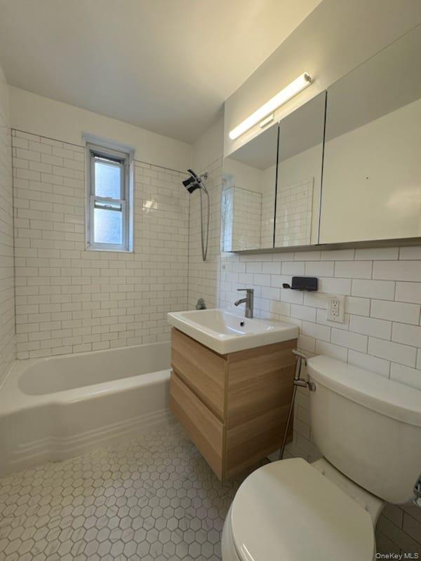 35-40 75th Street, Unit 3B Queens, NY 11372 - Photo 6 of 6 Full bath featuring tile walls, vanity, shower / bath combination, and backsplash