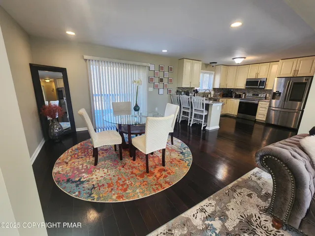 a view of a hallway with a livingroom and furniture