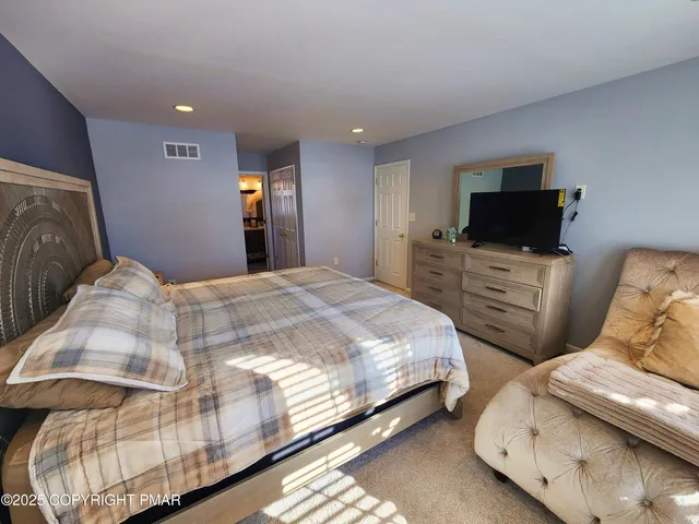 a bedroom with a bed and a dresser