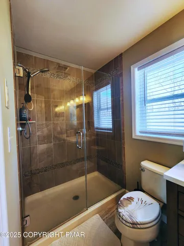 a living room with furniture a flat screen tv and gym equipment