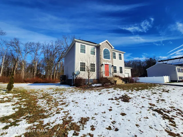 a living room with a bed furniture and a flat screen tv