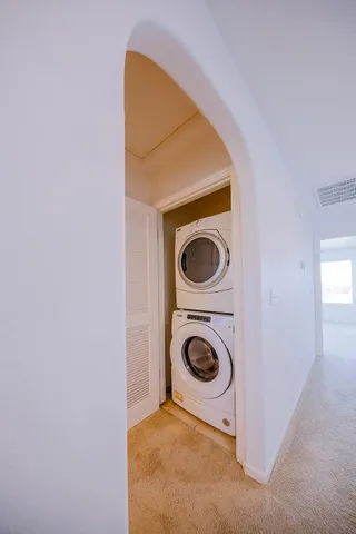 an empty room with a window and a ceiling fan