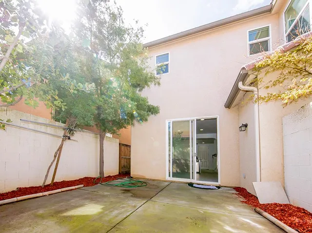 a view of a house with backyard and sitting area