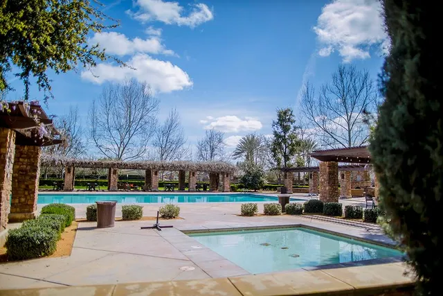 a front view of a house with a yard and potted plants