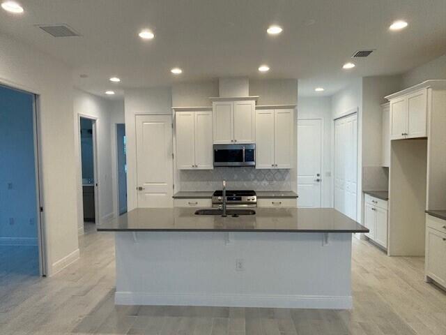 3110 Avalonia Drive Melbourne, FL 32940 - Photo 2 of 8 a kitchen with stainless steel appliances granite countertop a refrigerator a stove and a sink