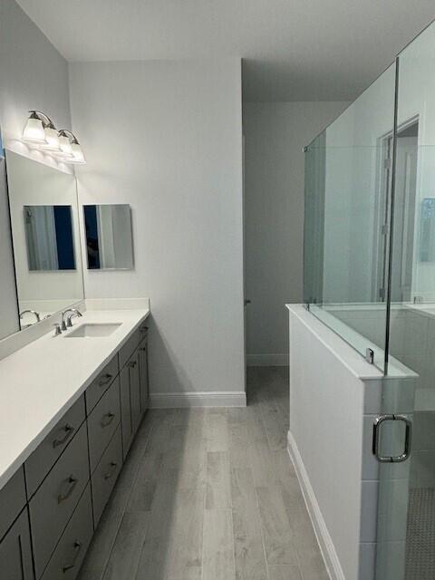 3110 Avalonia Drive Melbourne, FL 32940 - Photo 4 of 8 a bathroom with a double vanity sink and mirror