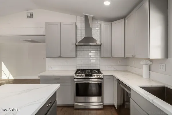 a kitchen with a stove and white cabinets