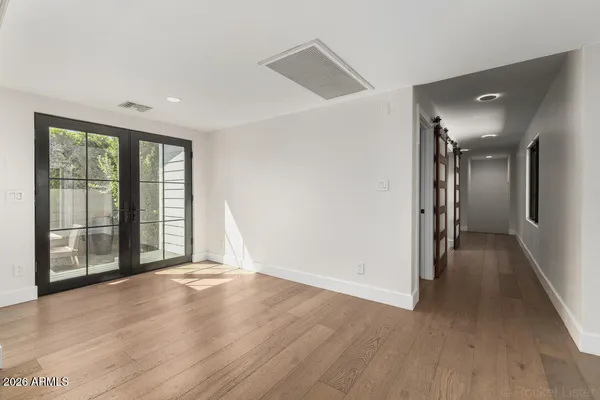 wooden floor in an empty room with a window