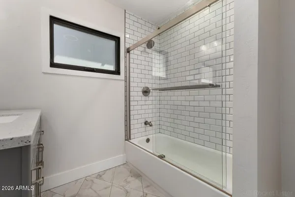 a bathroom with a bathtub and shower
