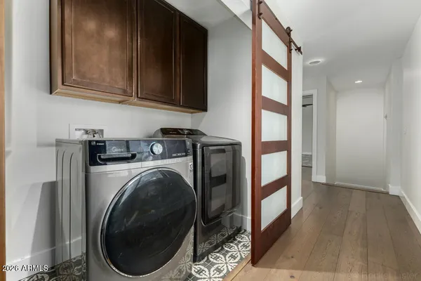 a view of a hallway with washer and dryer