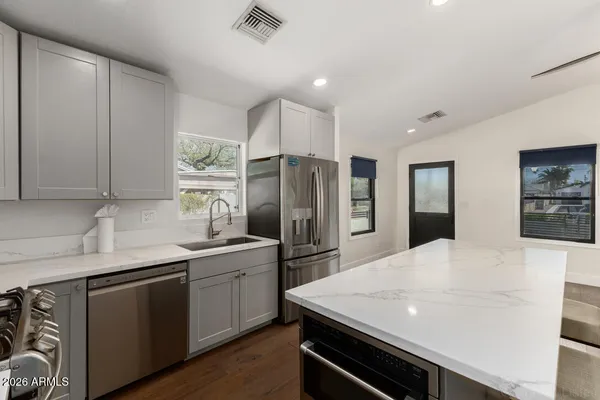 a kitchen with a refrigerator and a sink