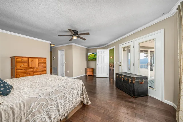 a bedroom with a bed and furniture with wooden floor