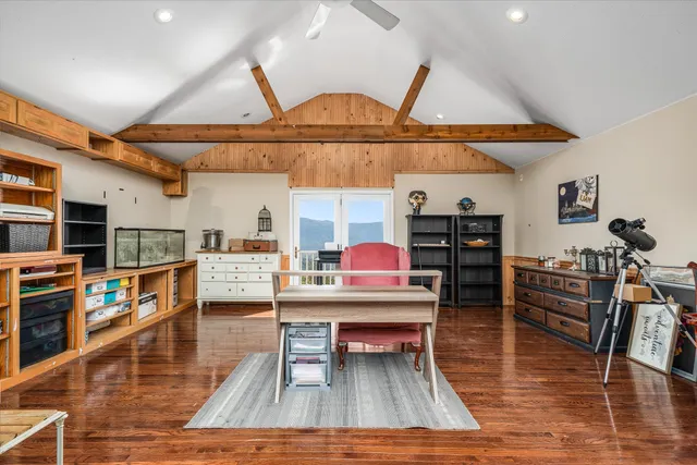 a view of a roof deck with wooden floor and outdoor seating